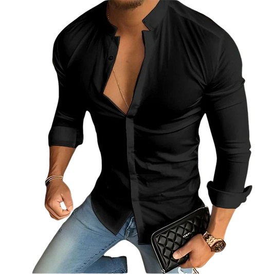 Man wearing a black button-up shirt with rolled-up sleeves, holding a black clutch.