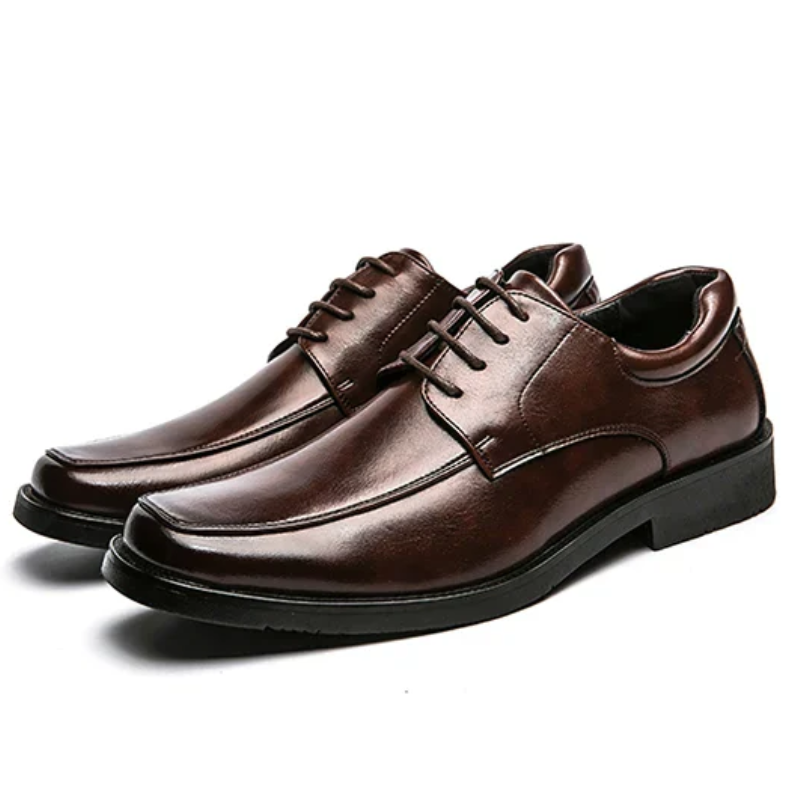 Pair of brown leather dress shoes on a white background
