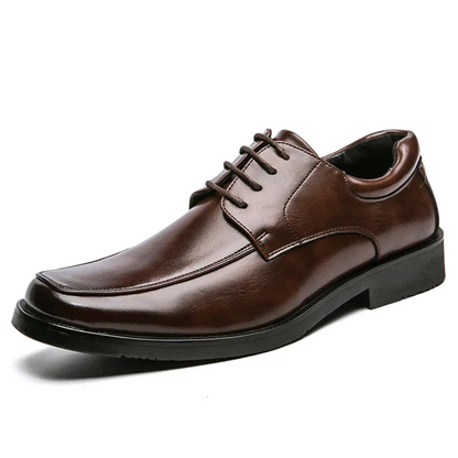 Brown leather dress shoe on a white background