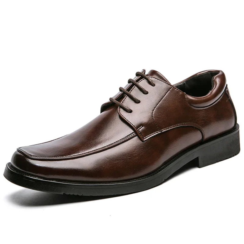 Brown leather dress shoe on a white background
