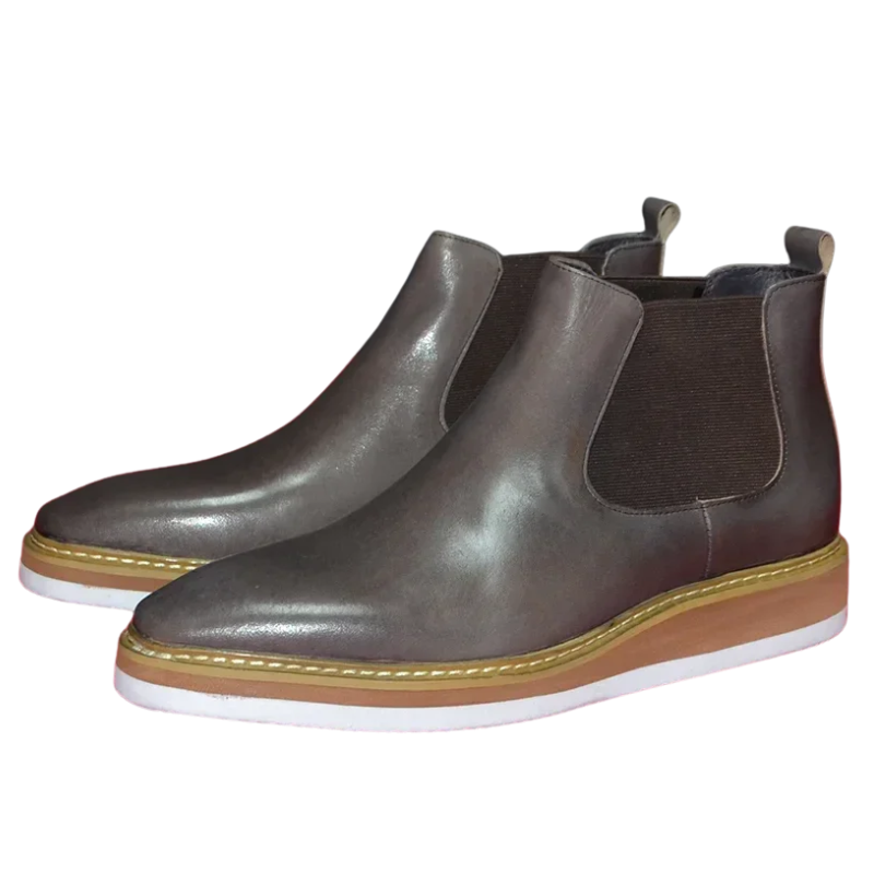 Pair of brown leather Chelsea boots on a white background