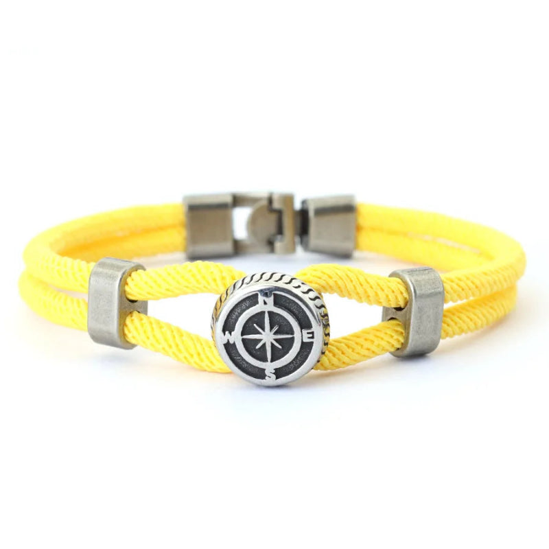 Yellow bracelet with a silver compass charm
