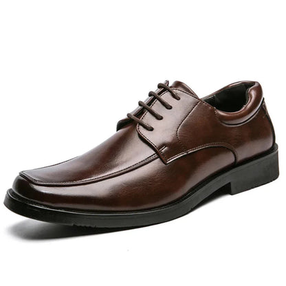 Brown leather dress shoe on a white background