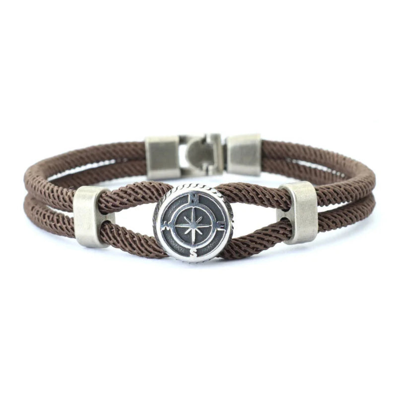 Brown braided bracelet with silver compass charm