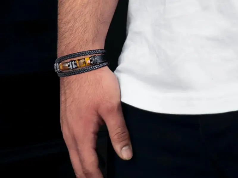 Close-up of a hand wearing a black leather bracelet