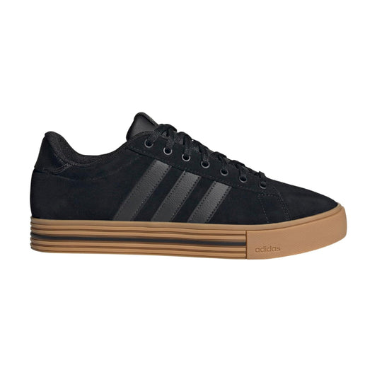 A black Adidas low-top sneaker with three dark gray stripes, black laces, and a thick tan gum sole, shown in a side profile on a white background.